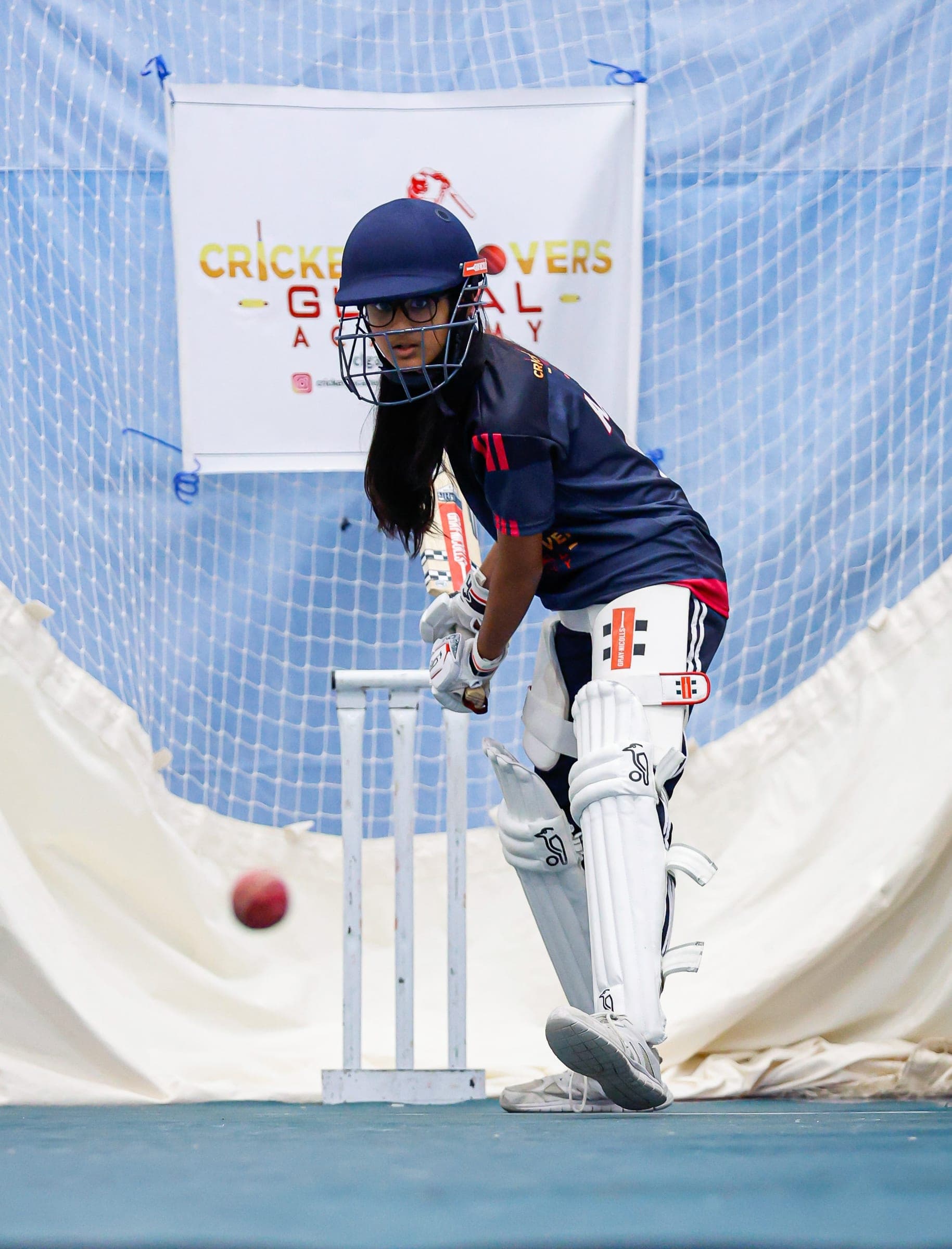 Girl batting in academy nets